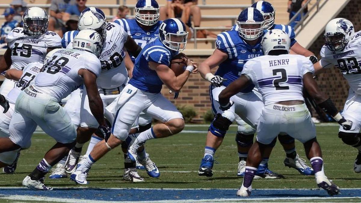 
Duke quarterback Thomas Sirk (1) attempts to get a first down against the Wildcat defense in the first half of play at Wallace Wade Stadium in Durham.
