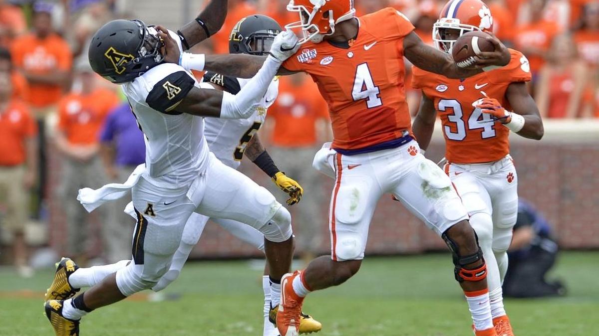 
Clemson quarterback Deshaun Watson (4), who passed for 248 yards and three touchdowns on Saturday, fends off Appalachian State's Alex Gray.

