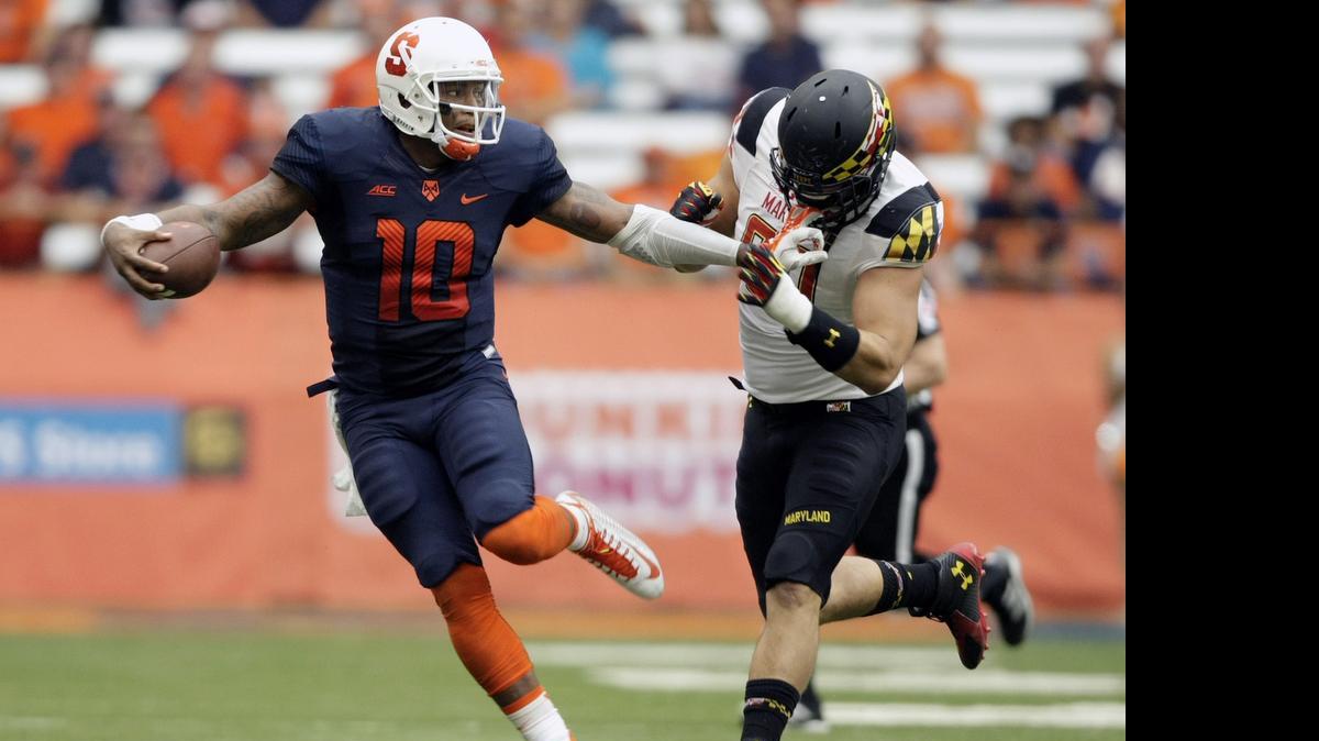 
Syracuse’s Terrel Hunt, left, grabs the face mask of Maryland’s Roman Braglio during their game at the Carrier Dome in Syracuse, N.Y., Saturday, Sept. 20, 2014. Maryland won 34-20. 
