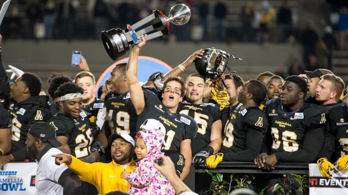 Quarterback Taylor Lamb of the Appalachian State Mountaineers hoists the Camellia Bowl trophy following Saturday night’s thriller.