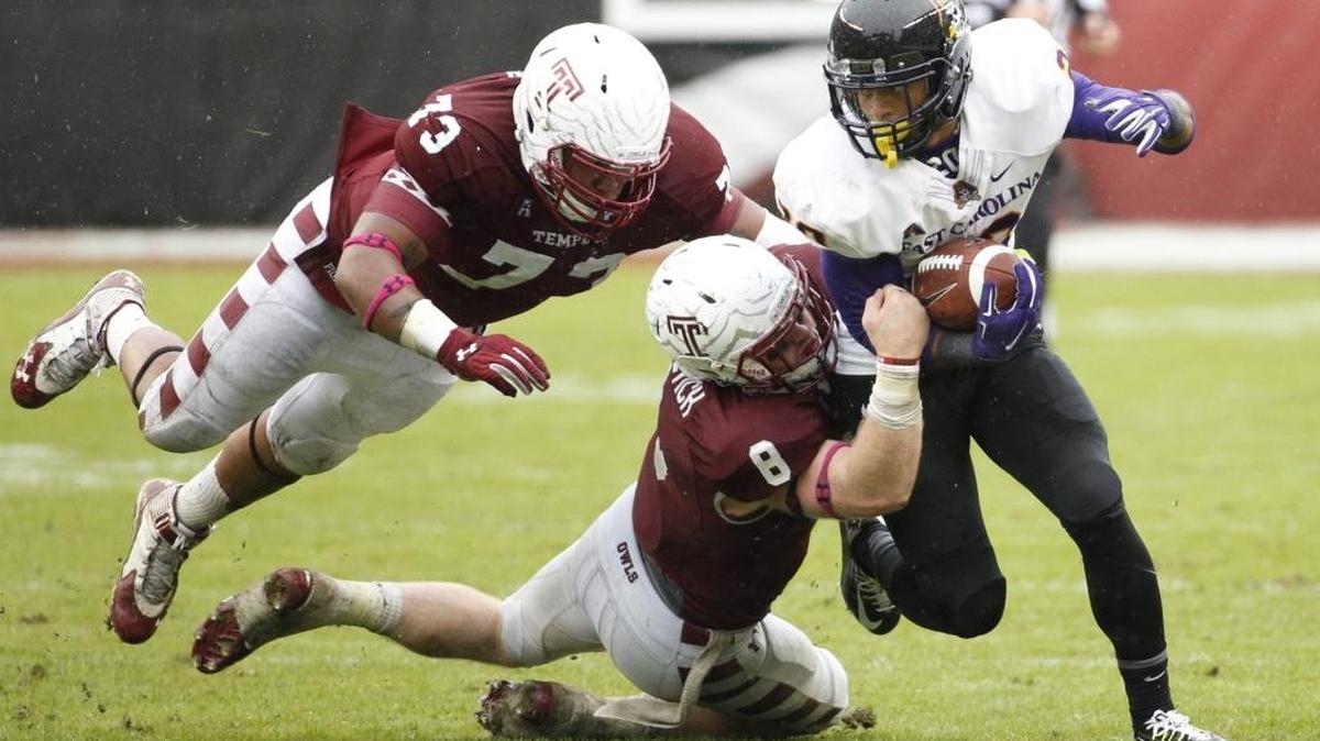 East Carolina’s Quay Johnson, right, runs as Temple’s Tyler Matakevich, center, and Averee Robinson, left, try to bring him down during Temple’s 20-10 win over the Pirates on Nov. 1, 2014. ECU faces No. 22 Temple Thursday night in Greenville.