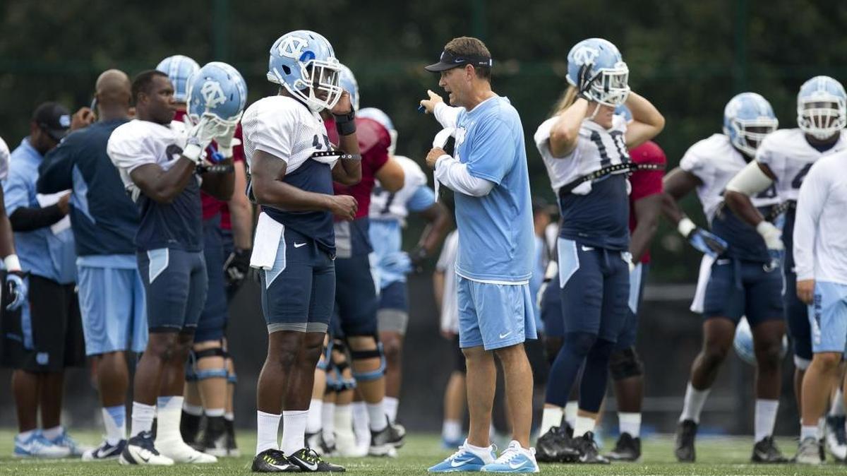 
North Carolina defensive coordinator Gene Chizik has a word with safety Donnie Miles (15) during the Tar Heels’ practice on August 25. Chizik, the former Auburn head coach, arrived in Chapel Hill in January with the task of rebuilding the defensive unit.
