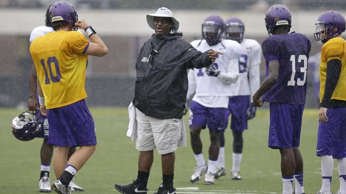 
East Carolina coach Ruffin McNeill directs quarterback Blake Kemp (10) during NCAA college football practice in Greenville on August 11, 2015. 
