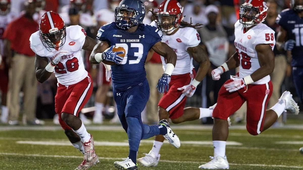 
Old Dominion’s Ray Lawry, breaks free from the North Carolina State defense  during an NCAA game. 
