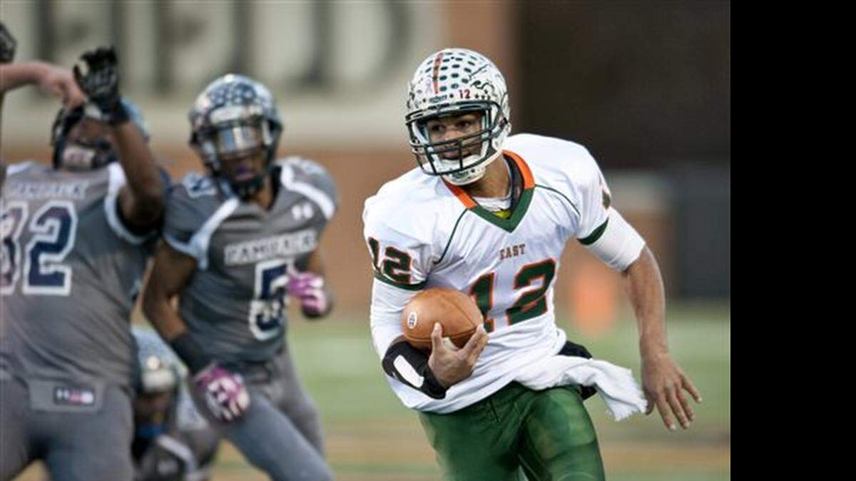 East Lincoln quarterback Chazz Surratt carries the ball during the NCHSAA 2AA State Championship high school football game held in Winston-Salem, N.C. Saturday, Dec. 14, 2014.