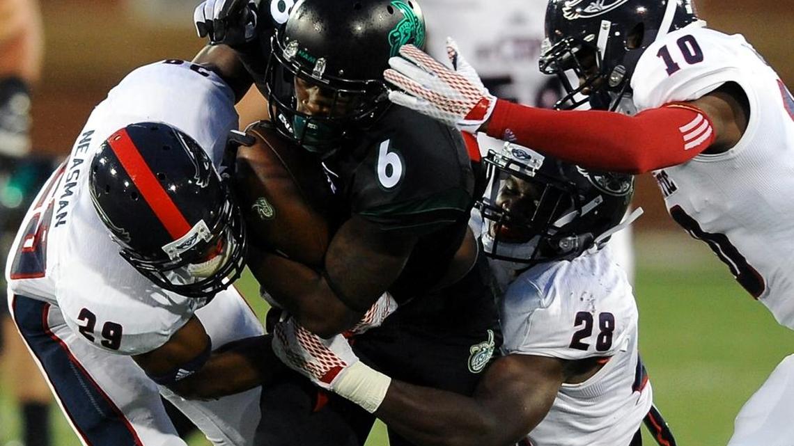 
Florida Atlantic strong safety Sharrod Neasman, left, linebacker Azeez Al-Shaair, center and cornerback Herb Miller cause Charlotte 49ers wide receiver Workpeh Kofa, center, to fumble the ball during first quarter action at Jerry Richardson Stadium on Saturday.
