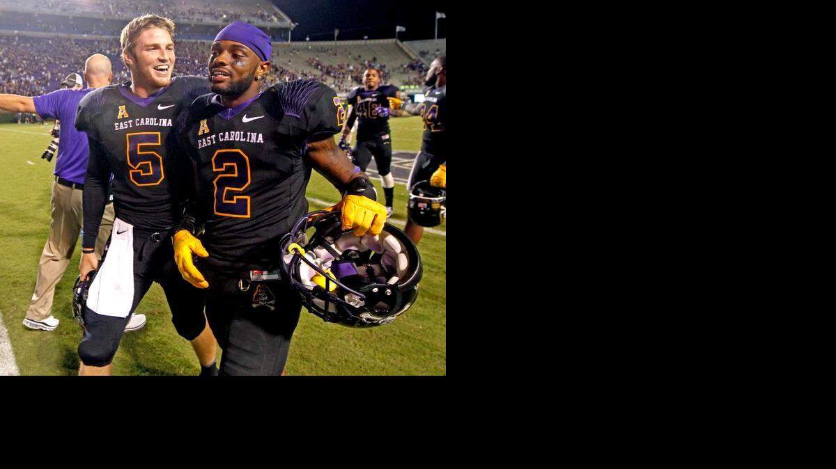 
East Carolina quarterback Shane Carden (5) and wide receiver Justin Hardy (2) walk off the field after East Carolina's 70-41 victory over North Carolina at Dowdy-Ficklen Stadium in Greenville, N.C., Saturday, Sept. 20, 2014.

