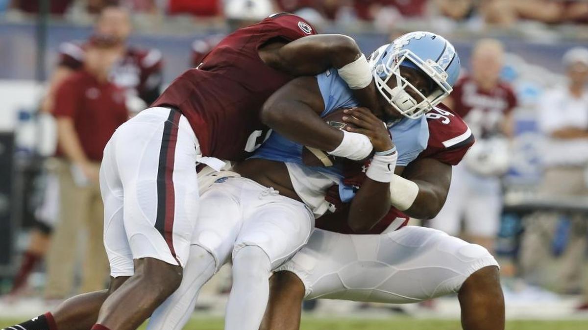 
UNC quarterback Marquise Williams (12) is sacked by USC defensive end Darius English (5) and defensive tackle Kelsey Griffin (94) during the Belk College Kickoff at Bank of America Stadium in Charlotte,.
