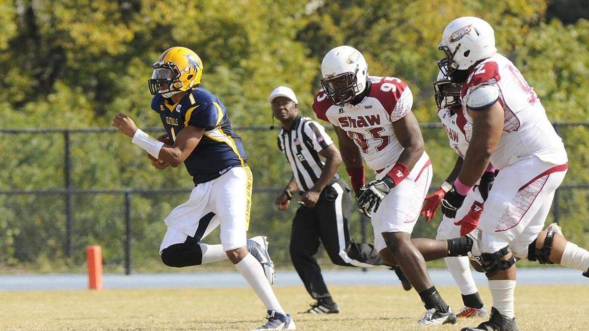 Pursued by several Shaw players Johnson C. Smith quarterback Jordan Lane (1) scrambles for a first down in the third quarter.
