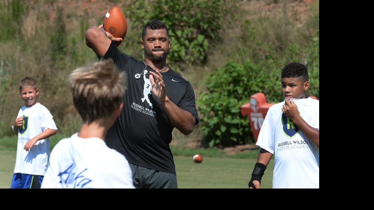 
Seattle Seahawks quarterback Russell Wilson fires off a pass during his annual football camp Tuesday, June 23, 2015. The Russell Wilson Passing Academy was attended by over 400 children who ran through various drills at the Carter-Finley practice fields.
