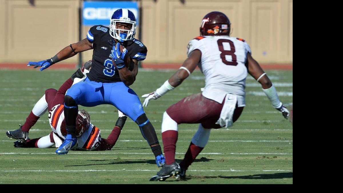 
Duke running back Josh Snead (9) looks for running room as Virginia Tech’s Detrick Bonner (8) defends last Novemberl. Duke lost 17-16 at Durham's Wallace Wade Stadium.
