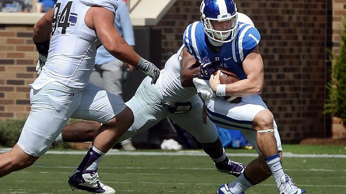
Duke quarterback Thomas Sirk (1) is sacked in the fourth quarter as Northwestern defensive lineman Dean Lowry (94) comes in to help out at Wallace Wade Stadium at Duke University in Durham, N.C. Saturday, September 19, 2015.
