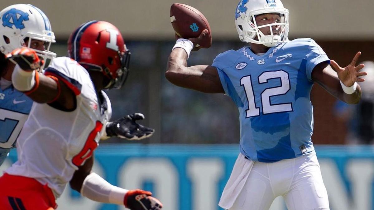 
North Carolina quarterback Marquise Williams (12) looks for Elijah Hood, connecting for a seven-yard gain in the first quarter against Illinois at Kenan Stadium in Chapel Hill.  
