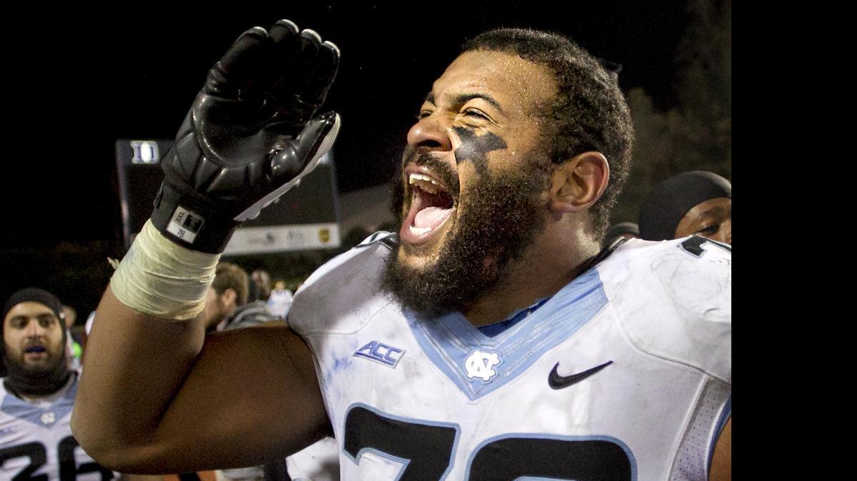 
UNC's Landon Turner (78) and his teammates celebrate their 45-20 victory over Duke on Thursday, November 19, 2014 at Wallace Wade Stadium in Durham, N.C.
