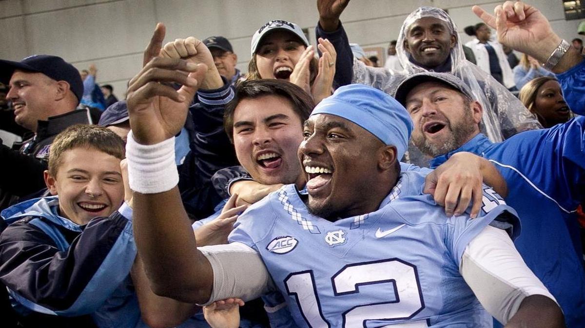 
North Carolina quarterback Marquise Williams celebrates the Tar Heels’ 38-31 victory over Georgia Tech with fans in Atlanta.
