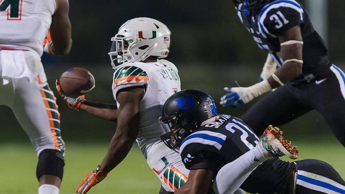 Duke cornerback Alonzo Saxton tackles Miami's running back Mark Walton during the eight-lateral play at the end of the Oct. 31 game. After a long video review of the play game officials ruled the Hurricanes player was not down and gave Miami the touchdown and win.