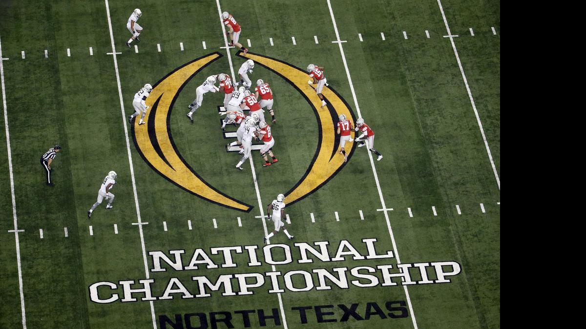 
FILE - In this Jan. 12, 2015, file photo, Ohio State, right, and Oregon play during the first half of the NCAA college football playoff championship game in Arlington, Texas. A four-person College Football Playoff management group visited Charlotte this week. The city hopes to host the national championship game in 2019 or 2020. 
