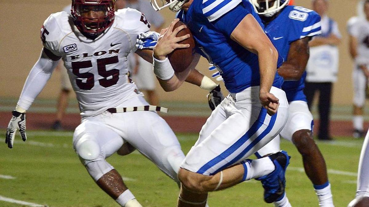 
Duke quarterback Thomas Sirk runs through the defense to score in the Blue Devils’ season-opening 52-13 win over Elon University on Aug. 30, 2014.
