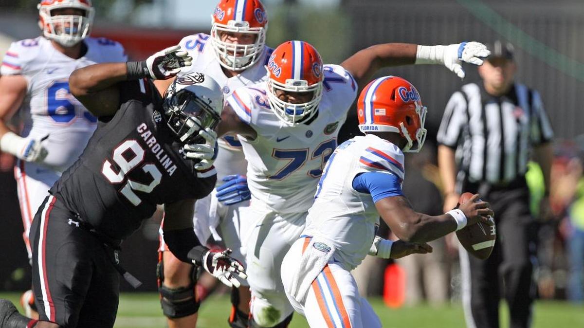South Carolina defensive tackle Gerald Dixon Jr. tries to pressure Florida quarterback Treon Harris on Saturday at Williams-Brice Stadium on Nov. 14.