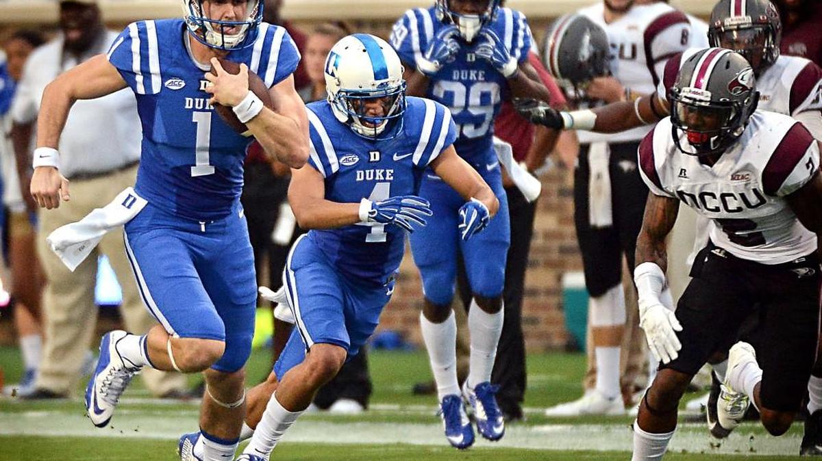 
Duke quarterback Thomas Sirk (1) runs for a first down in the second quarter as NCCU defensive back Ryan Smith (2) trails the play at Wallace Wade Stadium, Saturday, Sept. 12, 2015 in Durham, N.C.
