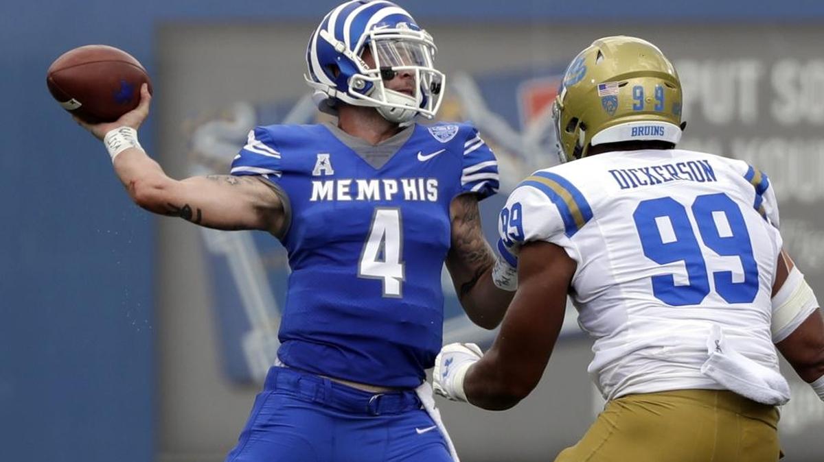 Memphis quarterback Riley Ferguson (4) passes as he is pressured by UCLA defensive lineman Matt Dickerson (99) in the first half of an NCAA college football game Saturday, Sept. 16, 2017, in Memphis, Tenn. (AP Photo/Mark Humphrey)