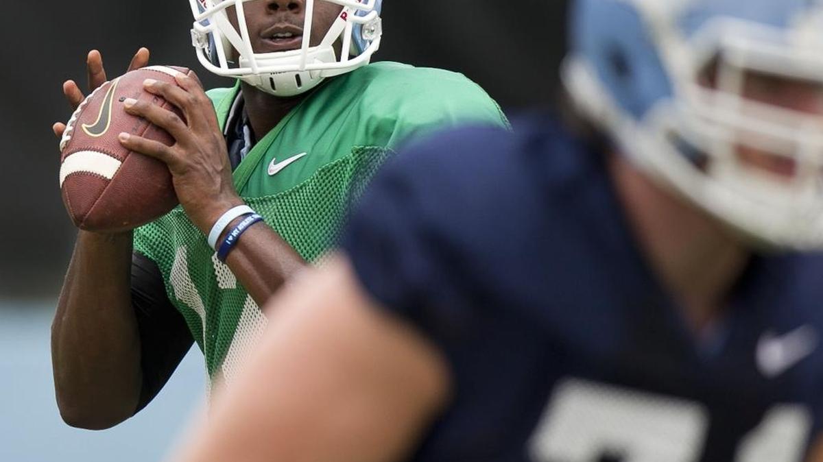 
North Carolina quarterback Marquise Williams (12) gets protection from offensive tackle Jon Heck (71) during the Tar Heels’ August 10 practice  at Navy Field in Chapel Hill.
