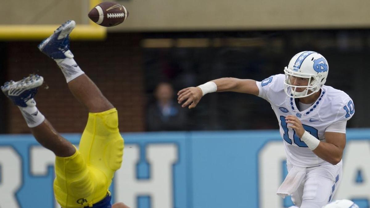 
North Carolina quarterback Mitch Trubisky (10) gets pass protection from Elijah Hood as he blocks Delaware’s Jalen Kindle (34), allowing him to connect with Kendrick Singleton for a 10-yard gain in the fourth quarter. Trubisky, coming off the bench, complete 17 of 20 passes for 312 yards and four touchdowns, leading North Carolina to a 41-14 victory. 
