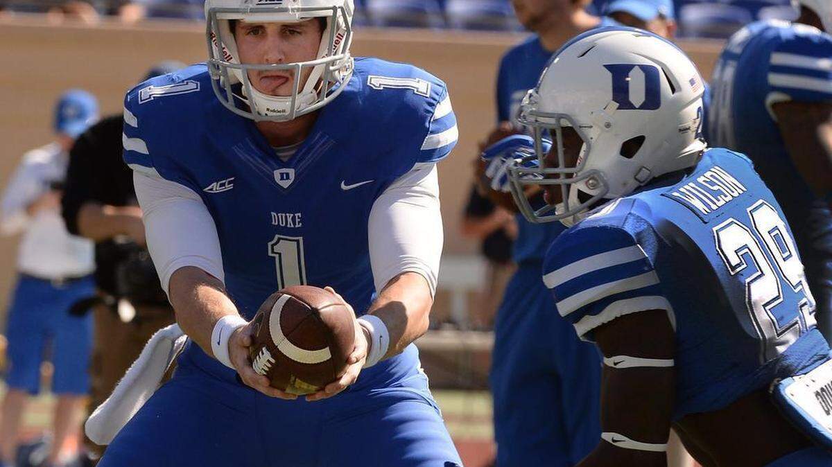 
Duke quarterback Thomas Sirk (1) hands off the ball to running back Shaun Wilson (29) during pre game warm-ups prior to their showdown with Virginia at Wallace Wade Stadium in Durham, NC Saturday, Sept. 18, 2014. 
