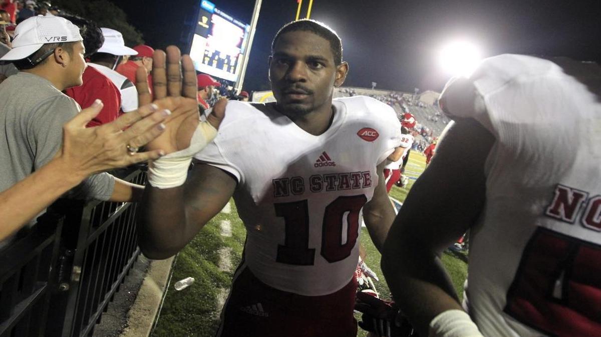 
N.C. State running back Shadrach Thornton (10) high-fives fans as he leaves the field after N.C. State's 38-14 victory over Old Dominion at S.B. Ballard Stadium in Norfolk, Va..
