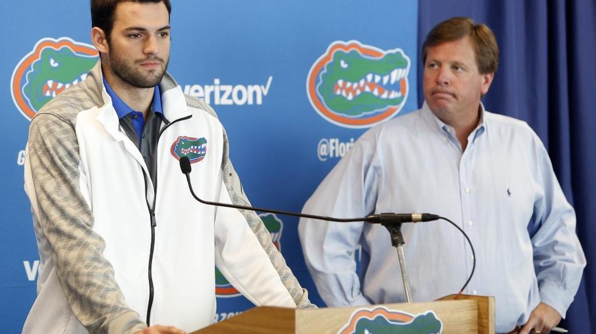 
Florida Gators quarterback Will Grier, left, speaks to members of the media as head coach Jim McElwain listens Monday, Oct. 12, 2015, in Gainesville, Fla. Grier has been suspended indefinitely for violating the NCAA's policy on banned performance-enhancing drugs. The school announced the suspension at the news conference on Monday. Grier, who failed a drug test, said he took an over-the-counter supplement.
