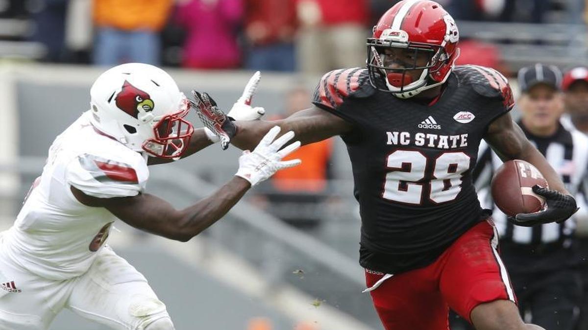 
N.C. State's Jaylen Samuels (28) stiff-arms Louisville cornerback Shaq Wiggins (6) during the first half at Carter-Finley Stadium in Raleigh.
