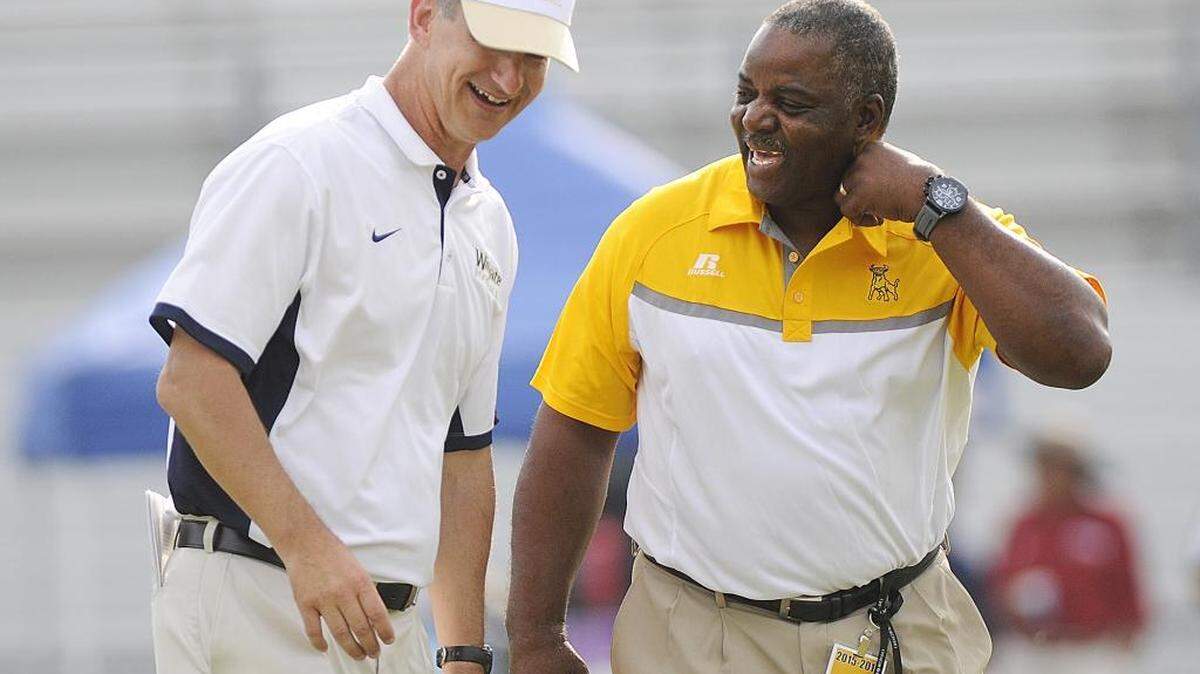 
(L-R) Joe Reich, Wingate's head coach and Kermit Blount, JCSU's head coach, share a laugh at midfield prior to kickoff Saturday. The Wingate Bulldogs faced off against the at Johnson C. Smith Golden Bulls in the opening game of the season for both teams. It is the debut for first-year J.C. Smith coach Kermit Blount. 
