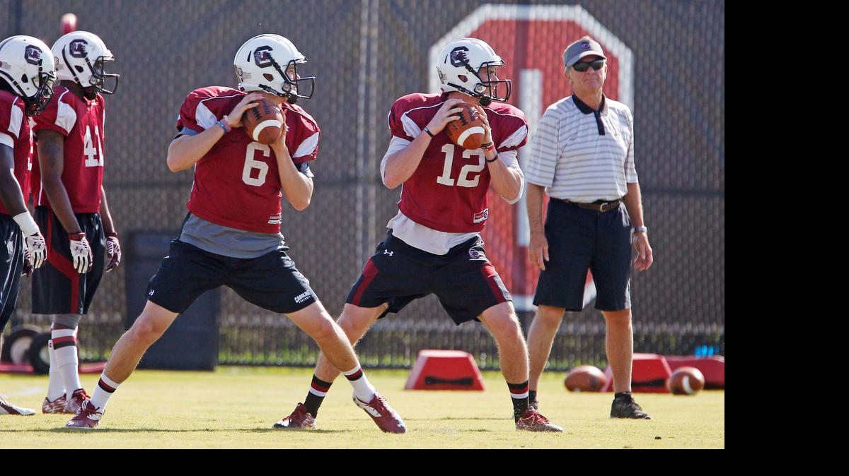 
South Carolina quarterbacks Connor Mitch (6) and Michael Scarnecchia (12) go through a passing drill in front of head coach Steve Spurrier during a spring football practice on Tuesday, March 31, 2015.
