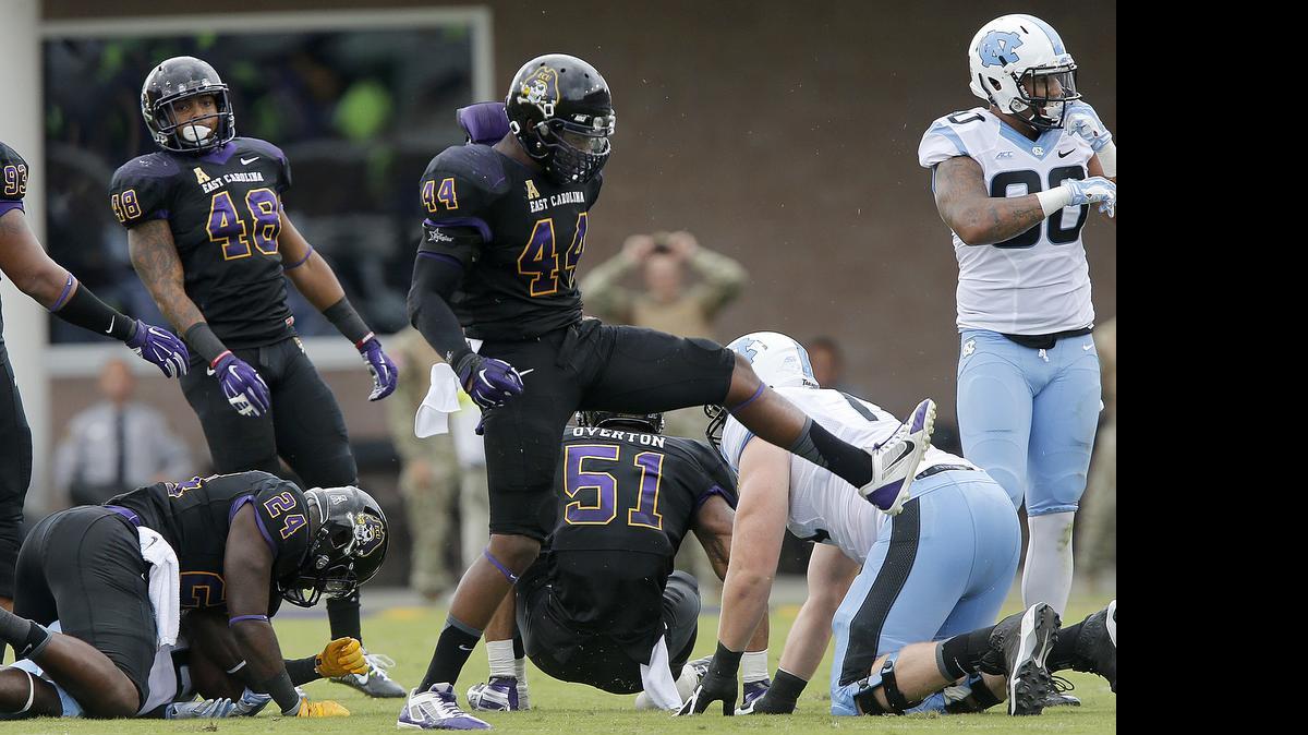 
East Carolina linebacker Zeek Bigger (44) celebrates after stopping North Carolina's Romar Morris (21) during the first half of UNC's game against East Carolina at Dowdy-Ficklen Stadium in Greenville, N.C., Saturday, September 20, 2014. 
