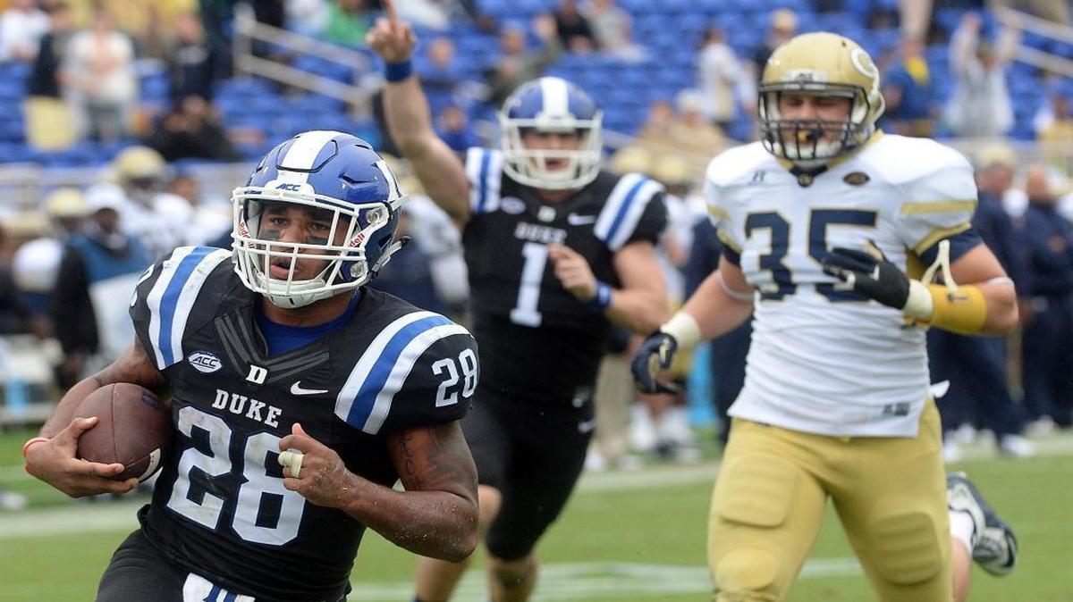 
Duke running back Shaquille Powell (28) scampers 28 yards on fourth-and-1 to score the Blue Devils’ final touchdown against Georgia Tech as quarterback Thomas Sirk (1) makes the call.
