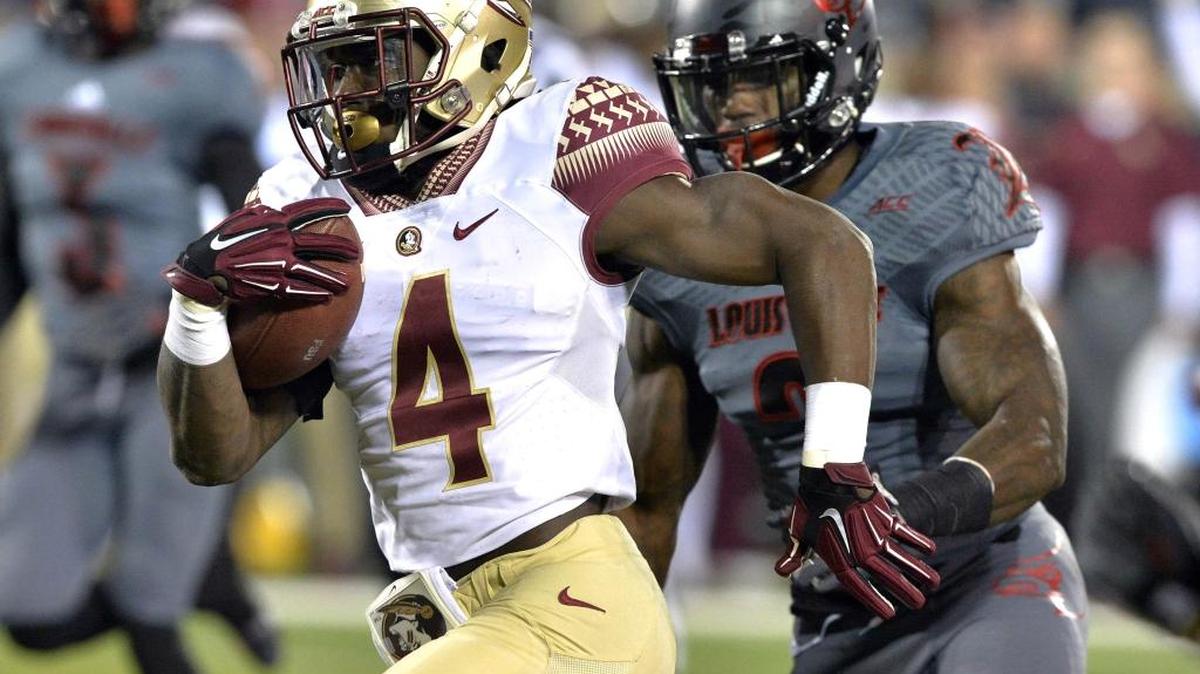 
Florida State's Dalvin Cook outruns the pursuit of Louisville's Charles Gaines to score a touchdown during their game in Louisville, Ky., on Oct. 30, 2014. 
