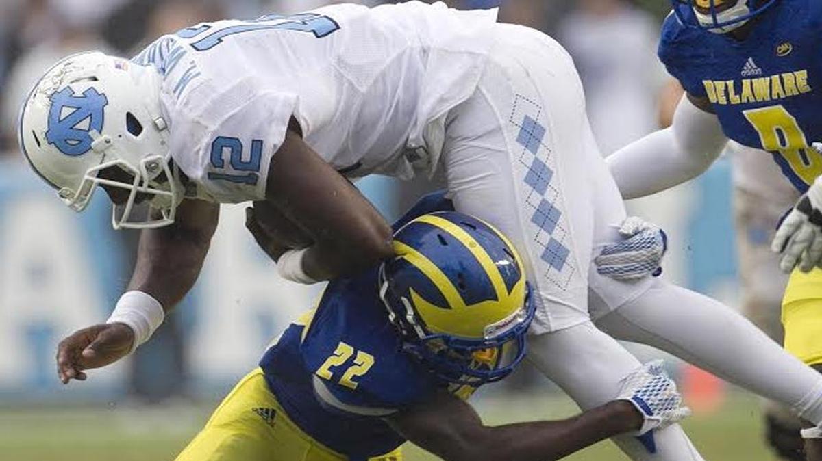 
North Carolina quarterback Marquise Williams rushes for 22 yards before being stopped by Delaware’s Justin Watson (22) in the second quarter on Saturday. Williams took some hard hits but coach Larry Fedora wouldn’t say if he’d sustained an injury.
