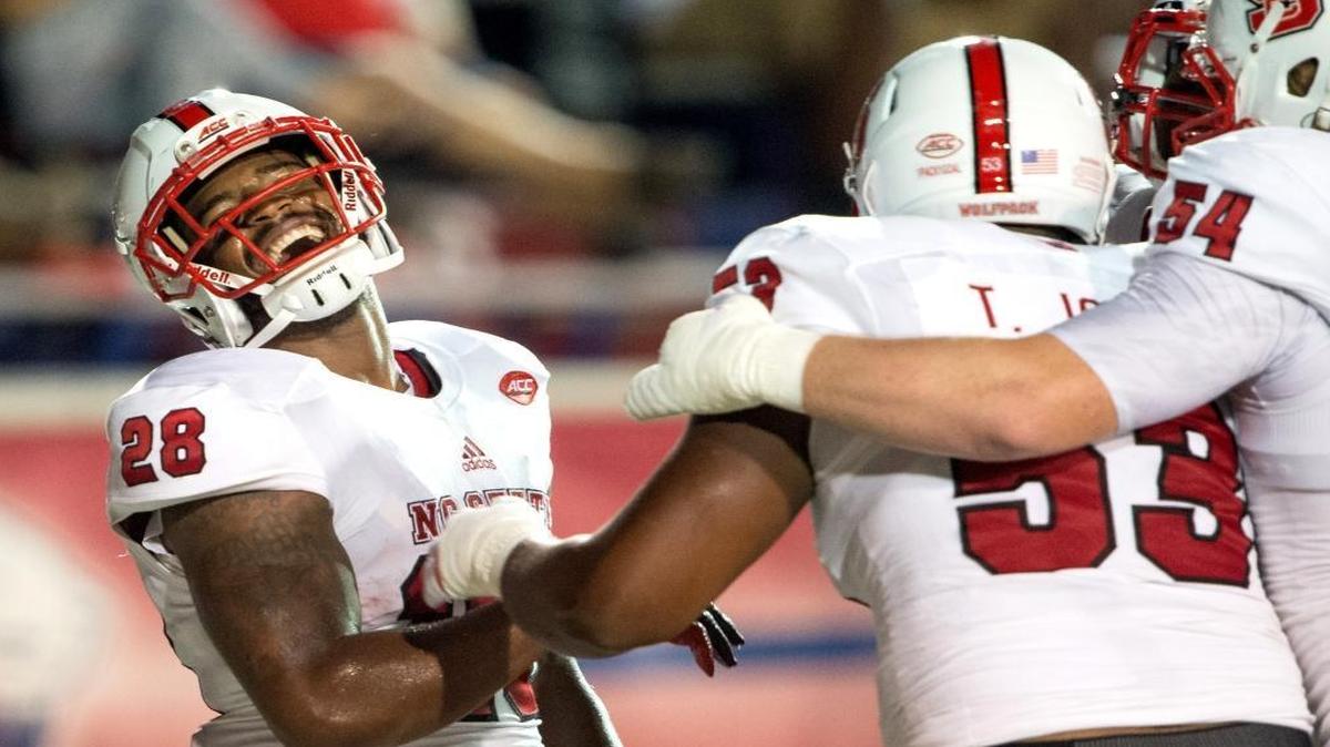 
N.C State’s Jaylen Samuels (28) celebratesa touchdown offensive tackle Tyler Jones (53) and guard Joe Thuney (54) during their game against the South Alabama 

