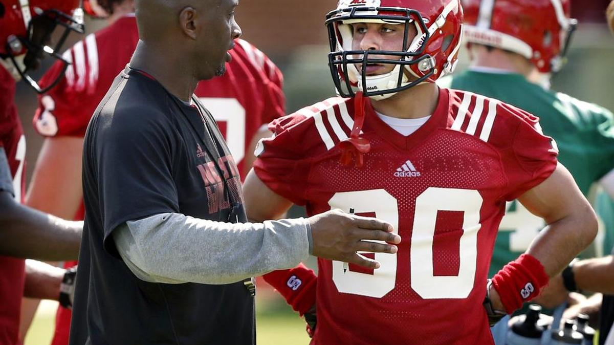 
N.C. State wide receivers coach George McDonald talks with Gavin Locklear (30) during the Wolfpack's first preseason practice Tuesday, August 4, 2015, in Raleigh, N.C.
