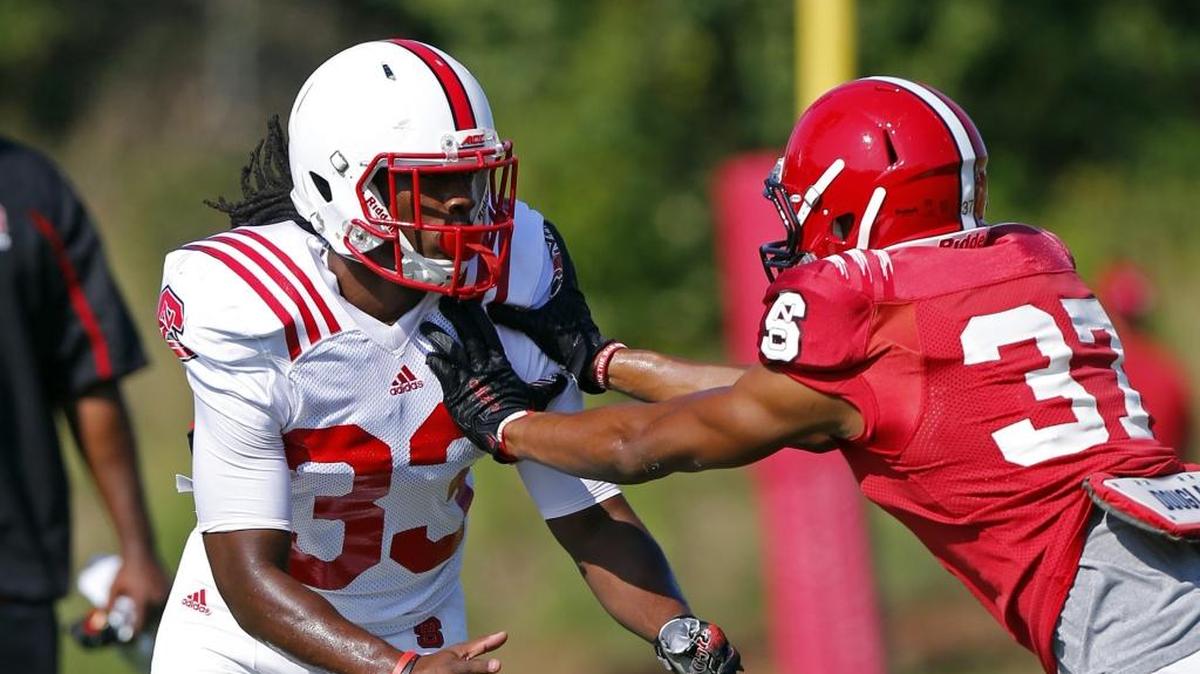 
CB Charlie Twitty (33) works against WR Josh Sessoms (37) at N.C. State football practice in Raleigh on August 12, 2015. 
