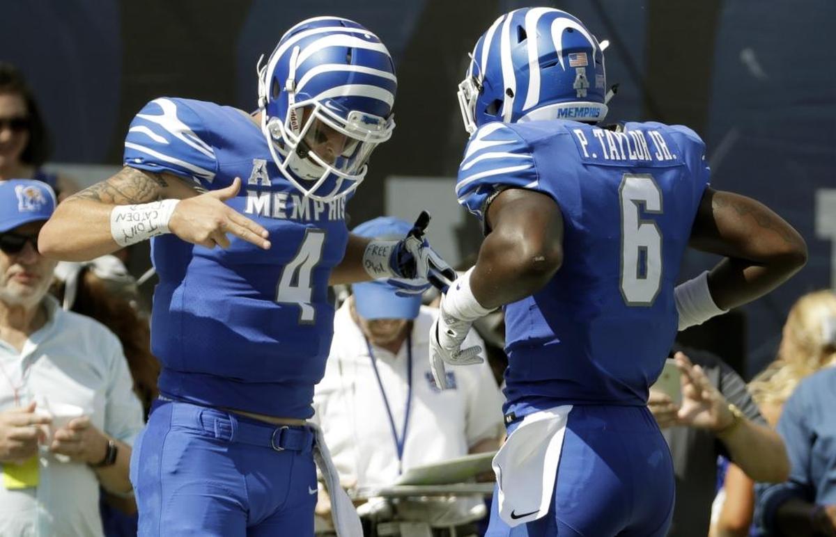 Memphis quarterback Riley Ferguson (4) celebrates with running back Patrick Taylor Jr. (6) after a score against UCLA in the first half of an NCAA college football game Saturday, Sept. 16, 2017, in Memphis, Tenn. (AP Photo/Mark Humphrey)