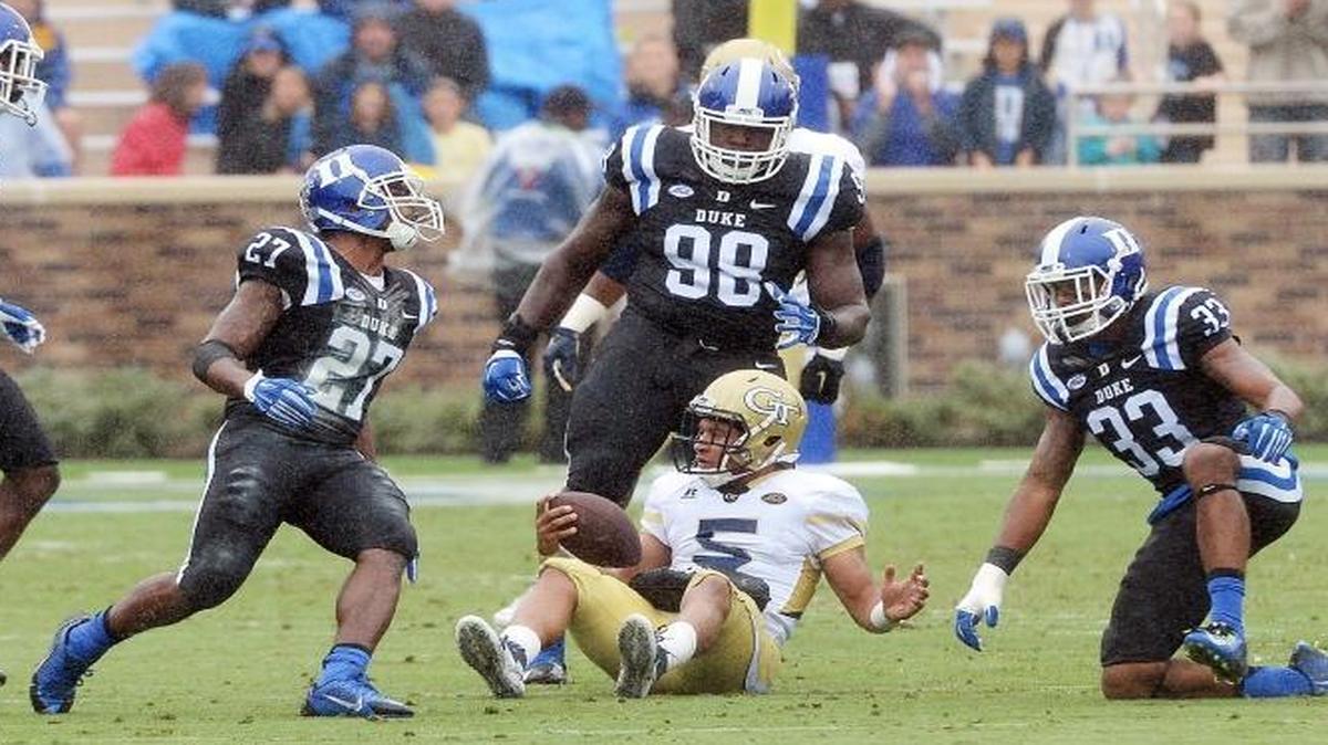 
The Duke defensive unit surrounds Georgia Tech quarterback Justin Thomas (5) as they stop him at the line of scrimmage in the second half of play. .
