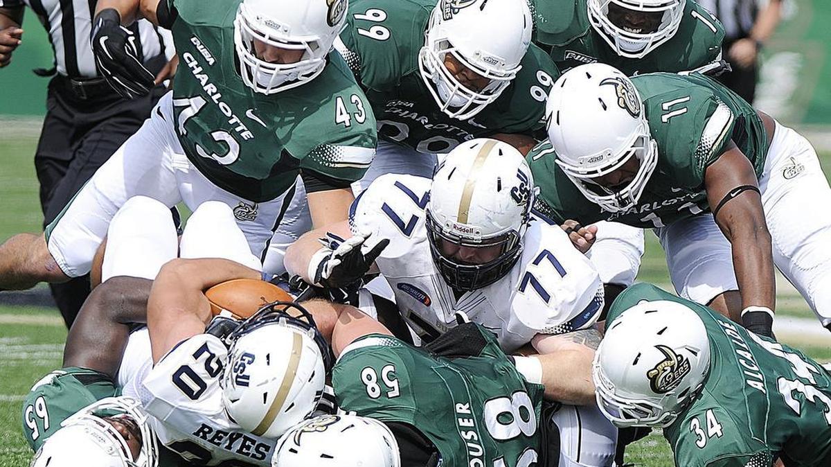 
The Charlotte 49er defense tackles Charleston Southern's Christian Reyes in a 47-41 Buccaneers victory in 2014.
