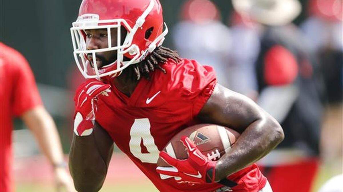 In this photo taken Aug. 4, 2015, Georgia running back Keith Marshall (4) carries the ball during NCAA college football practice in Athens, Ga. Marshall's return to good health is a big reason Georgia believes it will have quality depth behind tailback Nick Chubb this season. Marshall hasn't been the same since running for 759 yards as a freshman in 2012.