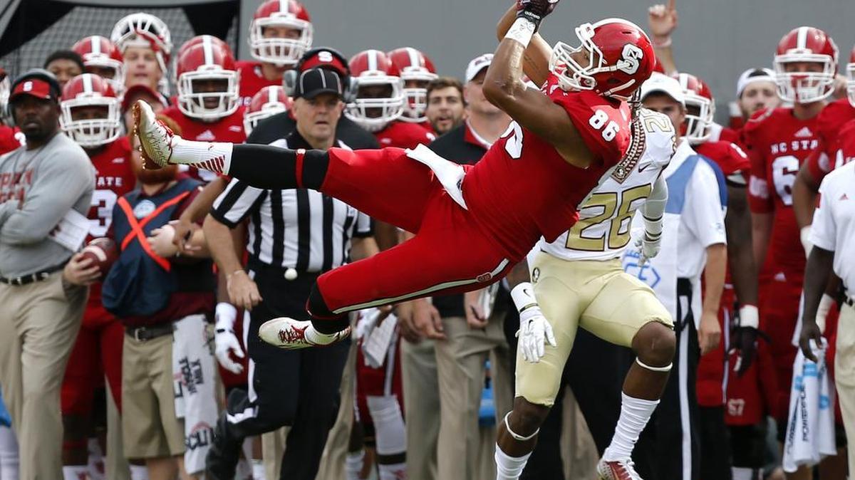 
N.C. State tight end David Grinnage (86) pulls in a reception in front of Florida State defensive back P.J. Williams (26) at Carter-Finley Stadium in Raleigh, Saturday, Sept. 27, 2014.
