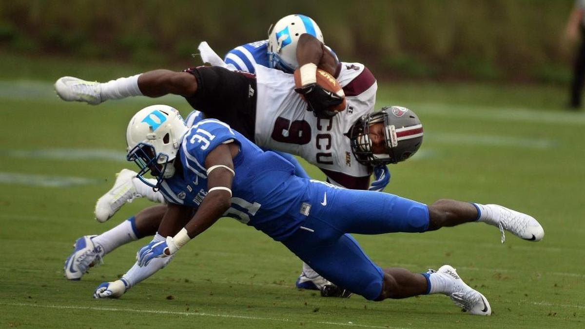 
Duke cornerback Breon Borders (31) and Duke safety DeVon Edwards (27) upend NCCU’s Jalen Wilkes (9) in the first quarter of play at Wallace Wade Stadium in Durham, N.C. Saturday, September 12, 2015.
