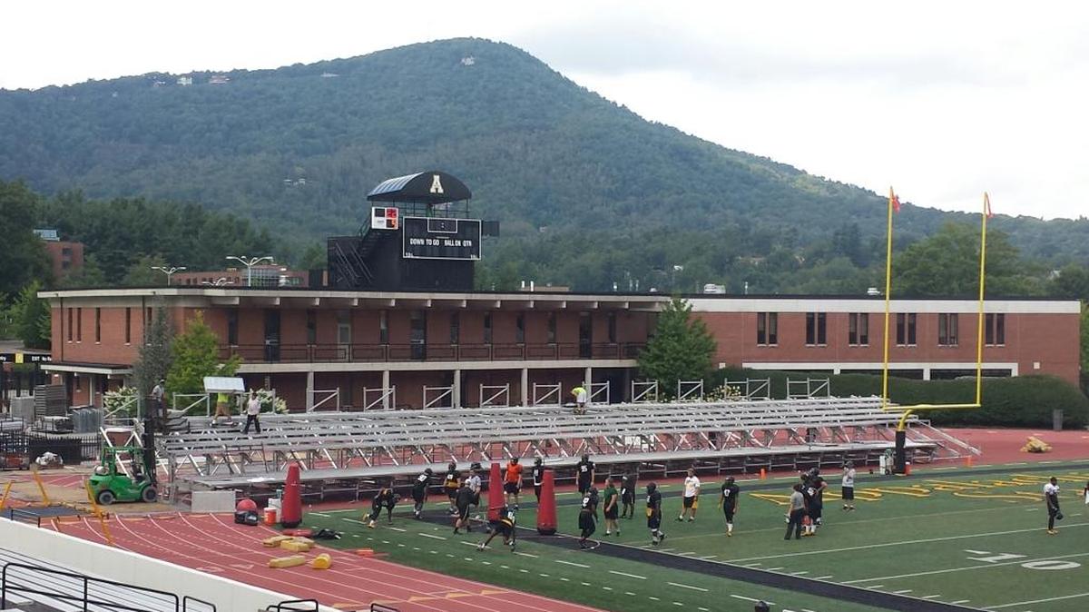 Appalachian State goes through practice on Wednesday as crews assemble bleachers behind an end zone at Kidd Brewer Stadium.