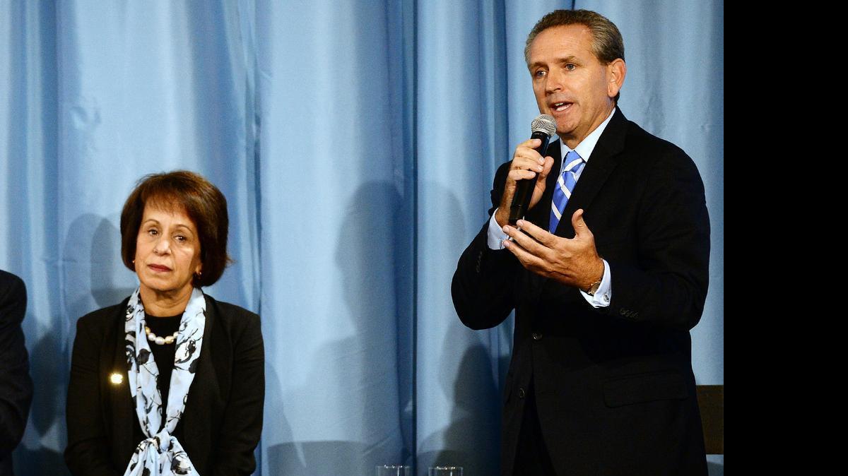 
UNC Chancellor Carol L. Folt listens as Bubba Cunningham, Director of Athletics, UNC-Chapel Hill answers a question about future NCAA sanctions during a press conference after a report was released on academic problems at Chapel Hill, NC Wednesday, October 22, 2014. 
