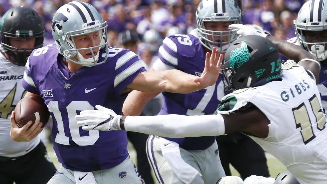 Kansas State quarterback Jesse Ertz (16) stiff arms Charlotte defensive back Marquavis Gibbs (15) on a long run near the end zone in the second quarter Saturday in Manhattan, Kan. Kansas State won 55-7.