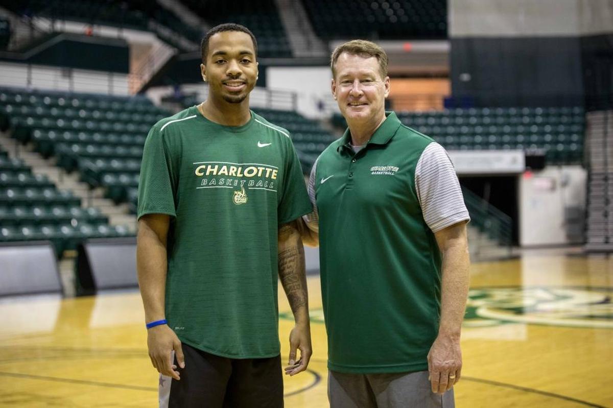 Charlotte 49ers point guard Jon Davis (left) and coach Mark Price posed for pictures during the basketball team’s preseason news conference at Halton Arena on Wednesday.
